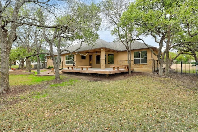 back of property featuring a lawn and a deck