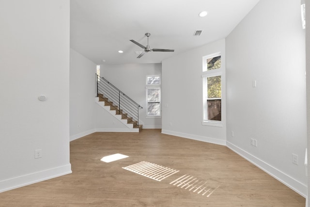 unfurnished living room featuring ceiling fan and light hardwood / wood-style flooring