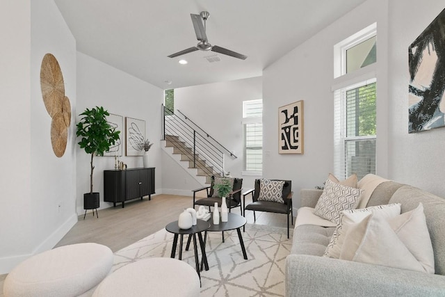 living room with light hardwood / wood-style flooring and ceiling fan