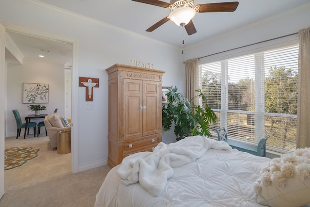 carpeted bedroom featuring ornamental molding and ceiling fan