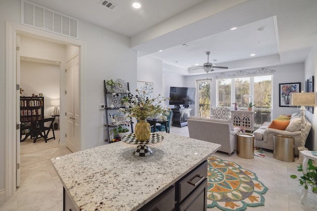 104 Bella Toscana Ave Unit 2211, Lakeway, TX 78734 - kitchen featuring ceiling fan, light tile patterned floors, recessed lighting, open floor plan, and light stone countertops