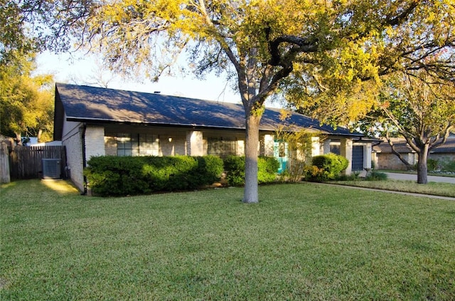 ranch-style home with cooling unit and a front yard