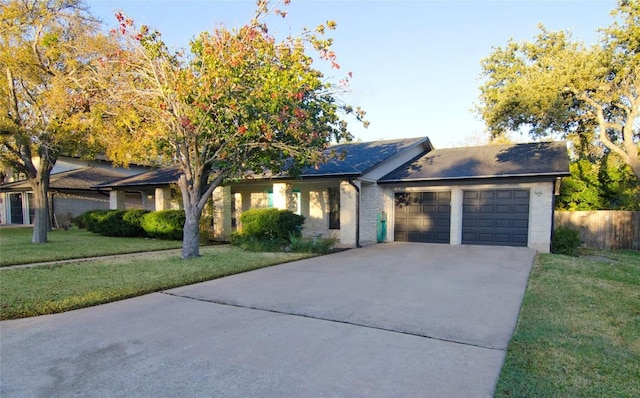 ranch-style house with brick siding, an attached garage, concrete driveway, and a front lawn