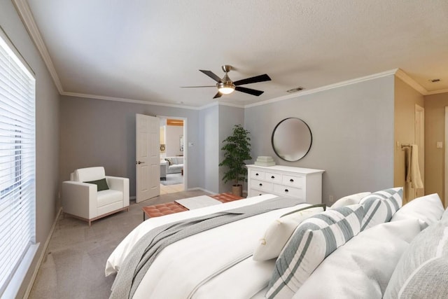 bedroom featuring visible vents, crown molding, baseboards, light carpet, and a ceiling fan