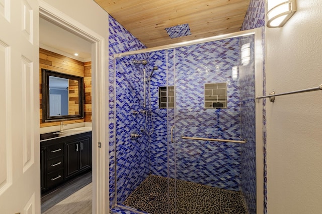 bathroom with wooden ceiling, wood finished floors, a stall shower, and vanity