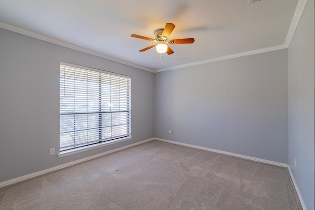 spare room with light colored carpet, baseboards, ceiling fan, and ornamental molding