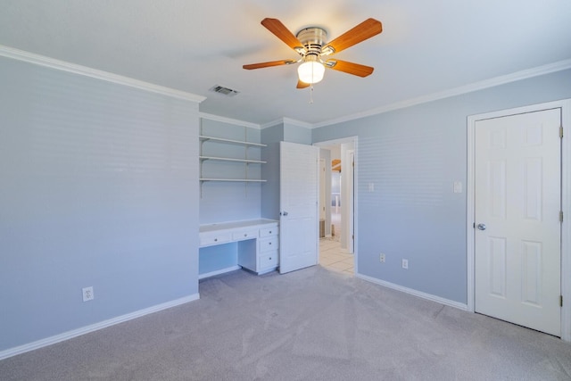 unfurnished bedroom with baseboards, light colored carpet, and crown molding