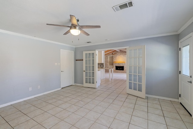 spare room with a ceiling fan, baseboards, visible vents, ornamental molding, and french doors