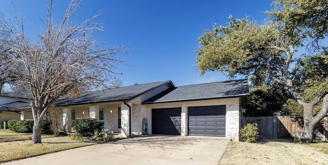 ranch-style house featuring brick siding, an attached garage, concrete driveway, and fence