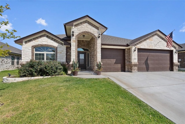 5204 La Terraza Ln, Killeen, TX 76549 - french country inspired facade featuring a garage, stone siding, a front yard, driveway, and brick siding