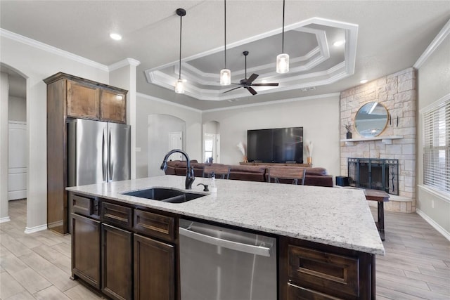 5204 La Terraza Ln, Killeen, TX 76549 - kitchen featuring appliances with stainless steel finishes, arched walkways, a ceiling fan, crown molding, and a tray ceiling