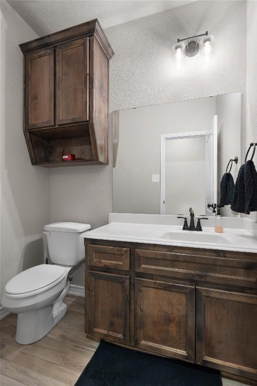 5204 La Terraza Ln, Killeen, TX 76549 - bathroom featuring vanity, a textured ceiling, and wood finished floors