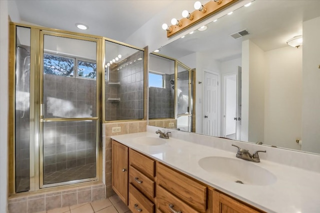 bathroom with vanity, tile patterned floors, and walk in shower