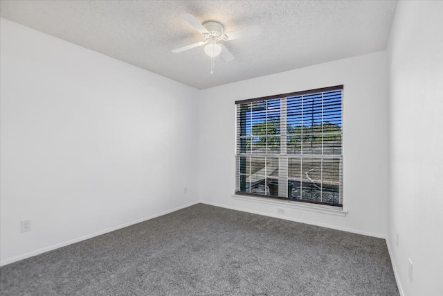 carpeted spare room with a textured ceiling and ceiling fan