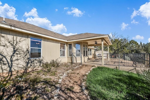 back of property featuring ceiling fan