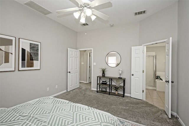 carpeted bedroom with ceiling fan and a high ceiling