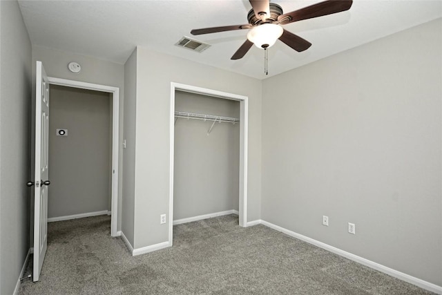 unfurnished bedroom with light carpet, ceiling fan, and a closet