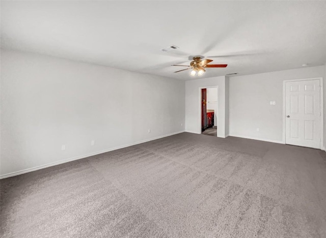 unfurnished room with ceiling fan and dark colored carpet