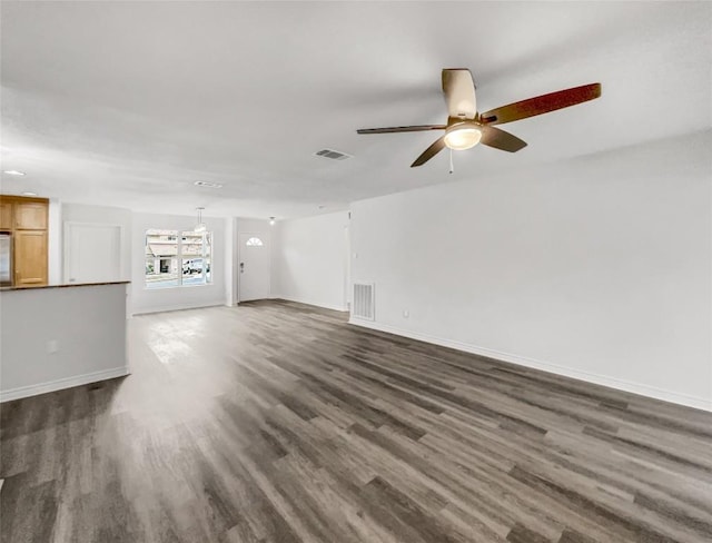 unfurnished living room with dark wood-type flooring and ceiling fan