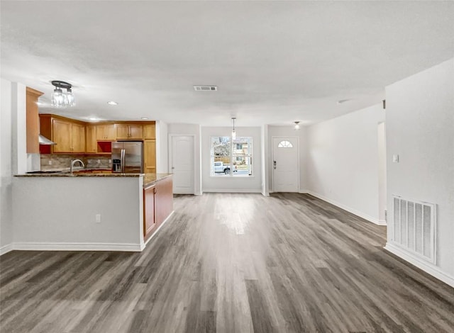 unfurnished living room featuring dark hardwood / wood-style floors and sink