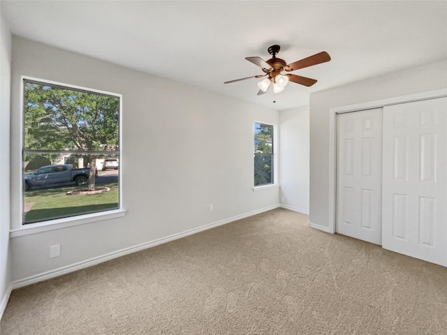 8222 Kearsarge Dr, Austin, TX 78745 - unfurnished bedroom featuring multiple windows, carpet floors, a closet, and a ceiling fan
