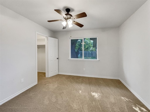 8222 Kearsarge Dr, Austin, TX 78745 - unfurnished bedroom with carpet floors, a walk in closet, baseboards, a ceiling fan, and a closet