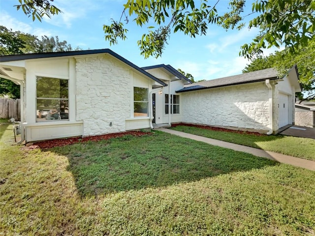 8222 Kearsarge Dr, Austin, TX 78745 - view of front of house with stone siding, a front lawn, and a garage