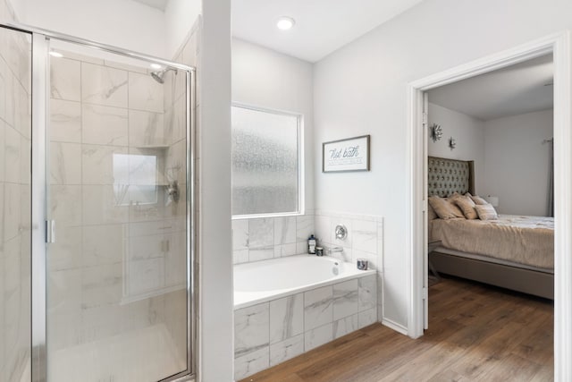 bathroom featuring hardwood / wood-style flooring and independent shower and bath