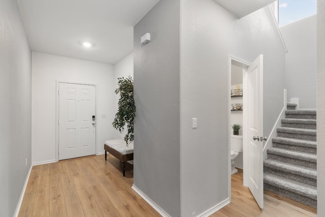 hallway with light hardwood / wood-style floors