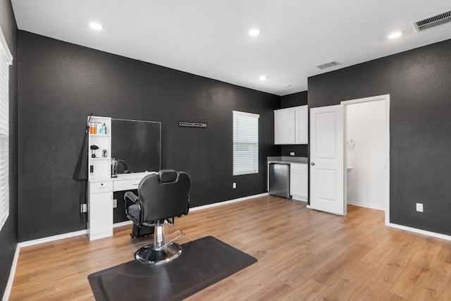 home office with light hardwood / wood-style flooring