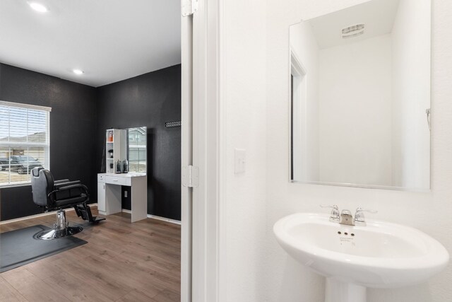 bathroom with hardwood / wood-style flooring and sink