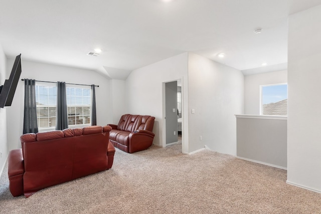 carpeted living room featuring lofted ceiling