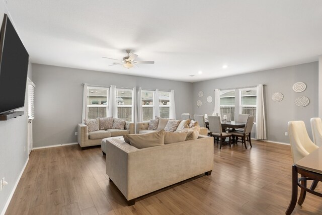 living room featuring ceiling fan and hardwood / wood-style floors