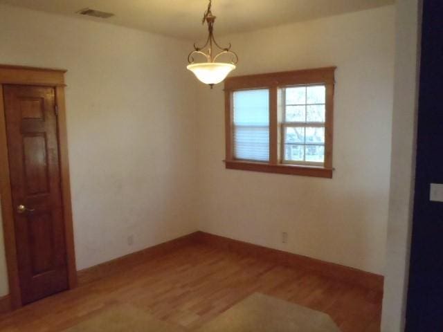 spare room with wood-type flooring