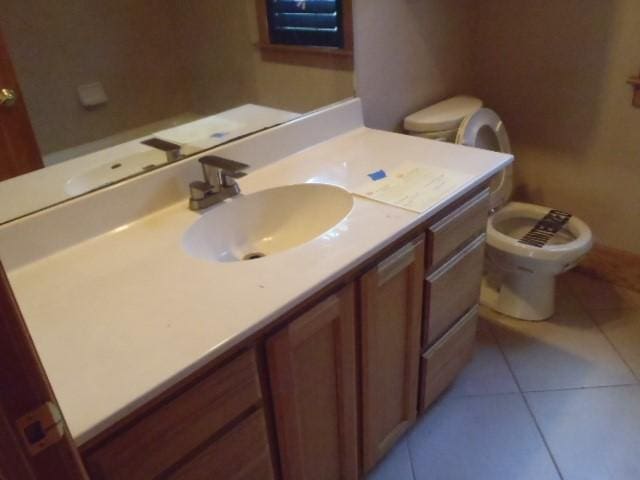 bathroom featuring vanity, tile patterned floors, and toilet