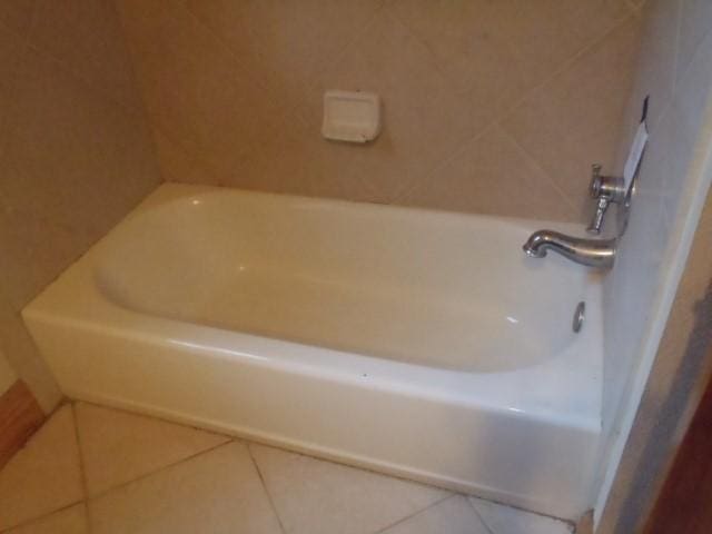 bathroom featuring a bath and tile patterned floors