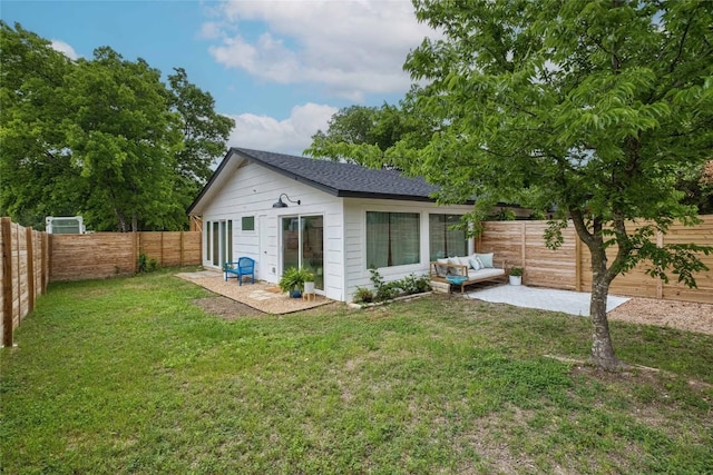 rear view of property featuring outdoor lounge area and a yard