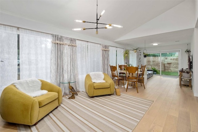 interior space featuring hardwood / wood-style floors, vaulted ceiling, and a chandelier