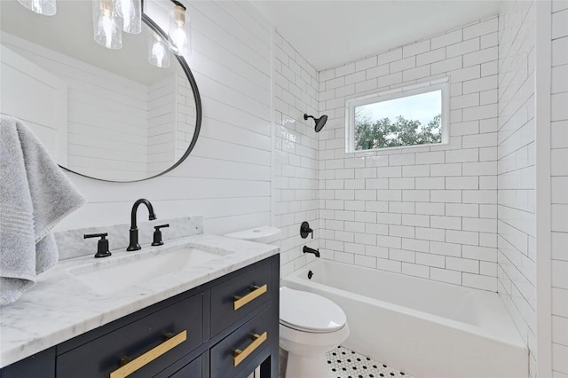 full bathroom with tiled shower / bath combo, vanity, and toilet