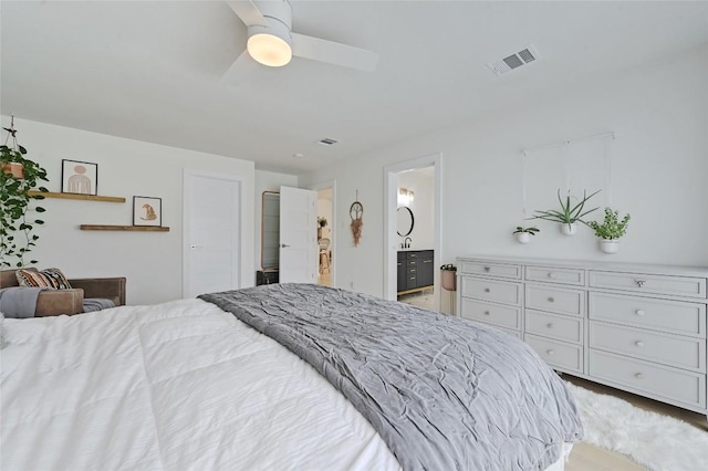 bedroom with ensuite bathroom and ceiling fan