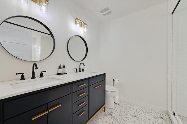 bathroom featuring vanity, toilet, and an enclosed shower