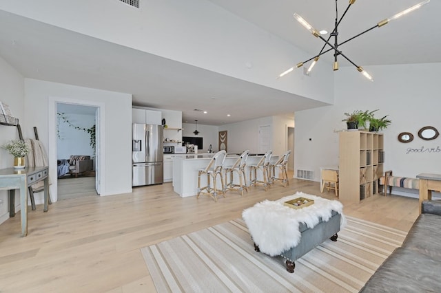 living room featuring a chandelier and light hardwood / wood-style floors