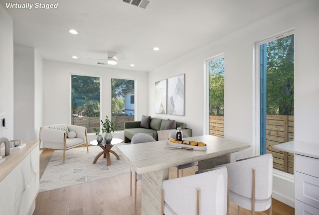 sunroom / solarium featuring ceiling fan