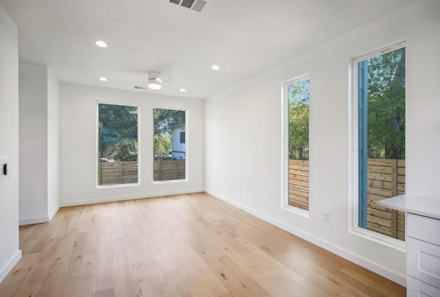 unfurnished room with ceiling fan and light hardwood / wood-style floors