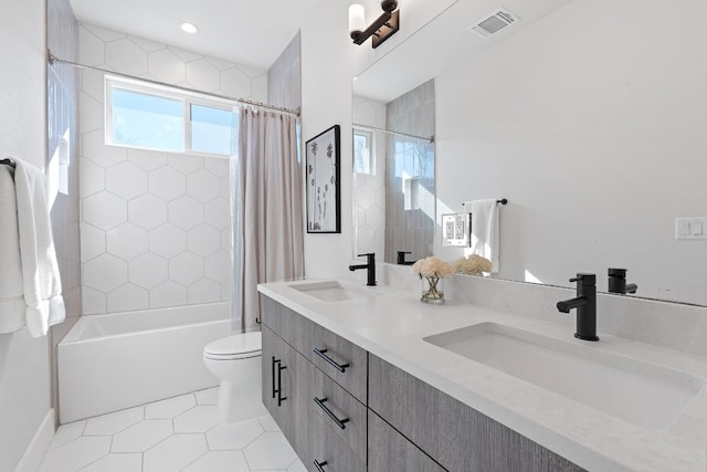 full bathroom featuring tile patterned floors, vanity, toilet, and shower / bath combo with shower curtain