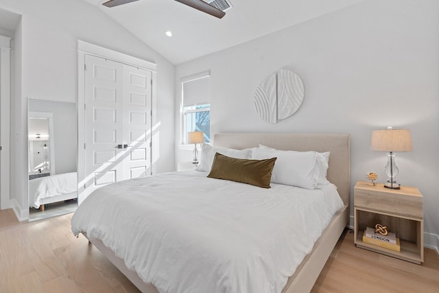 bedroom with vaulted ceiling, ceiling fan, and light wood-type flooring