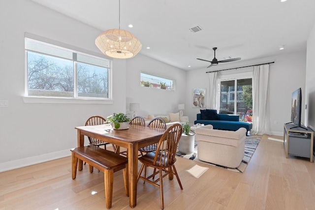 dining area with ceiling fan, a wealth of natural light, and light wood-type flooring