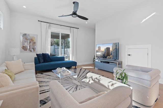 living room with light hardwood / wood-style flooring and ceiling fan