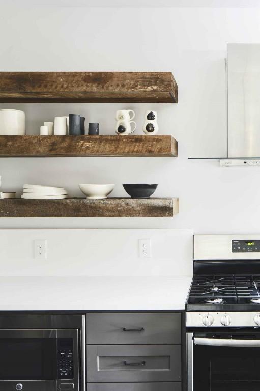 interior space featuring built in microwave, gray cabinets, and gas stove