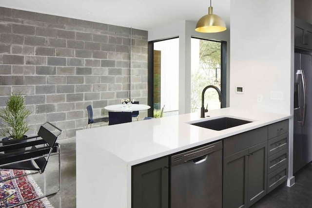 kitchen with dishwasher, sink, stainless steel fridge, and decorative light fixtures